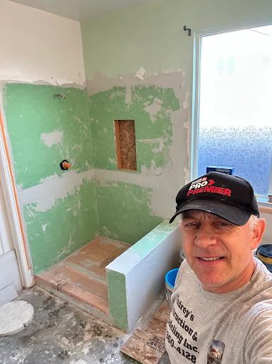 Andrey working on shower remodel in Fresno CA - waterproofing board installation