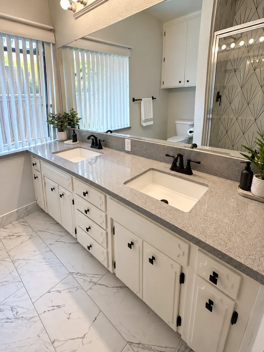 Double-sink vanity with granite-look countertop and matte-black fixtures in a Clovis, CA bathroom remodel